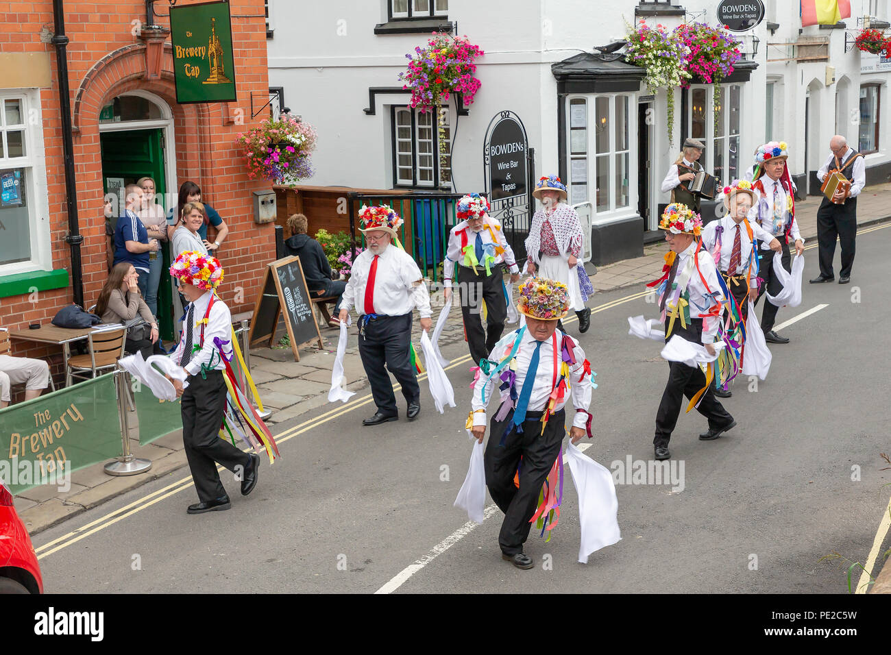 Warrington, UK. 12th August 2018. The ancient tradition of Lymm Rushbearing has been revived after an absence of two years. The event did not involve a procession on local highways as in the past, but after gathering near the Lower Dam about 4 pm and then processing up the Dingle, the festival ended with a service at St Mary’s Church Credit: John Hopkins/Alamy Live News Stock Photo