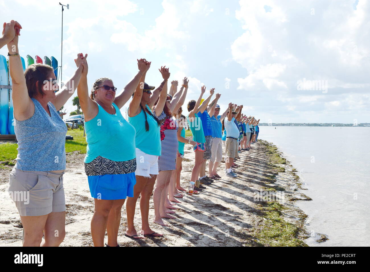 Hands Along the Water events in SW Florida to raise awareness of the disaster of Red Tide and algae affecting our waters, killing sea creatures, harming the environment and an environmental health hazard to humans. Stock Photo