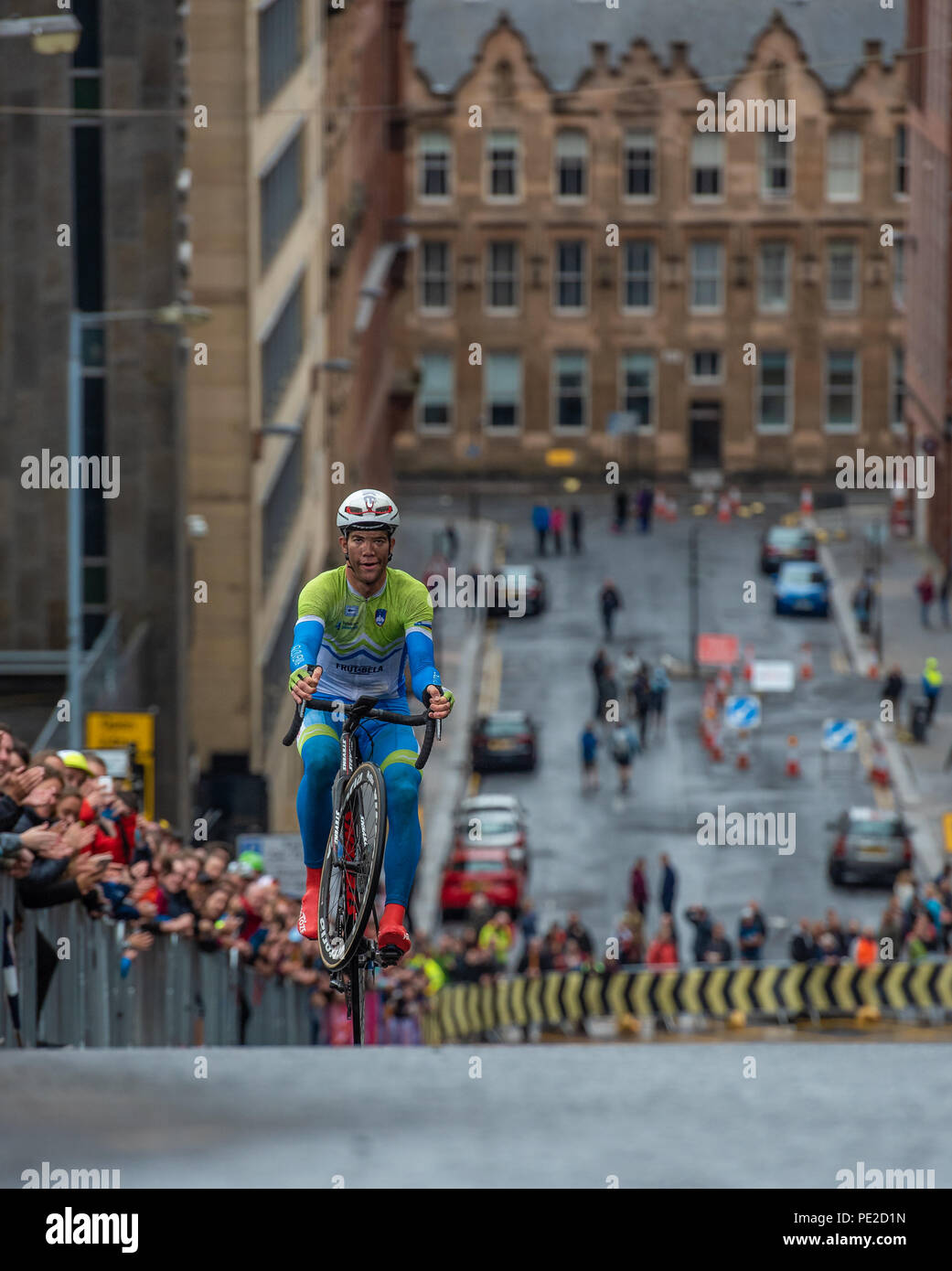 Glasgow, Scotland. 12th Aug, 2018. A Slovenian competitor with front wheel in the air at the European Championship Mens Cycling Road Race, at the top of a hill climb in Glasgow, Scotland. Credit George Robertson/Alamy Live News Stock Photo