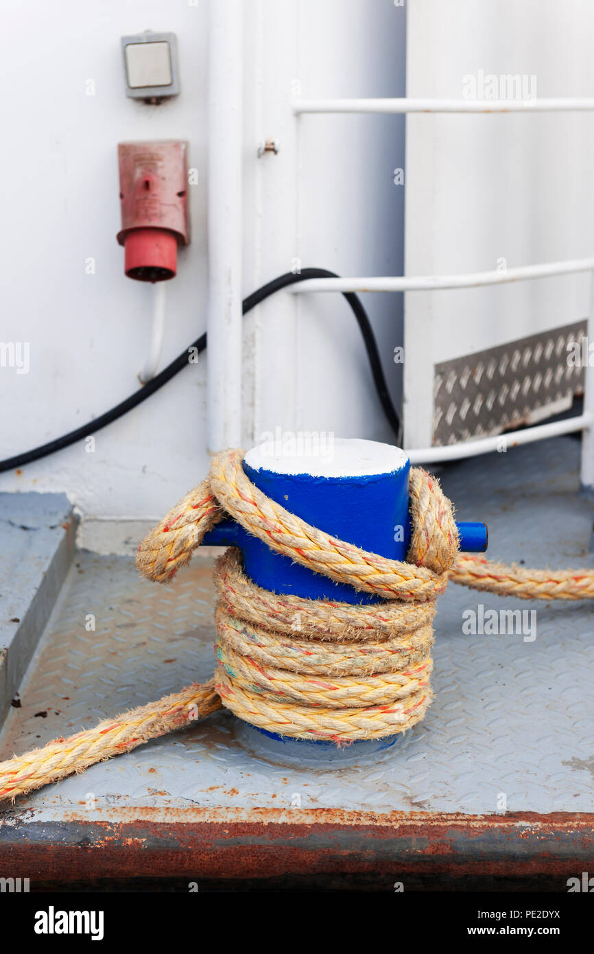 Blue bollard on a white passenger ship with marine rope in a north german harbor. Stock Photo
