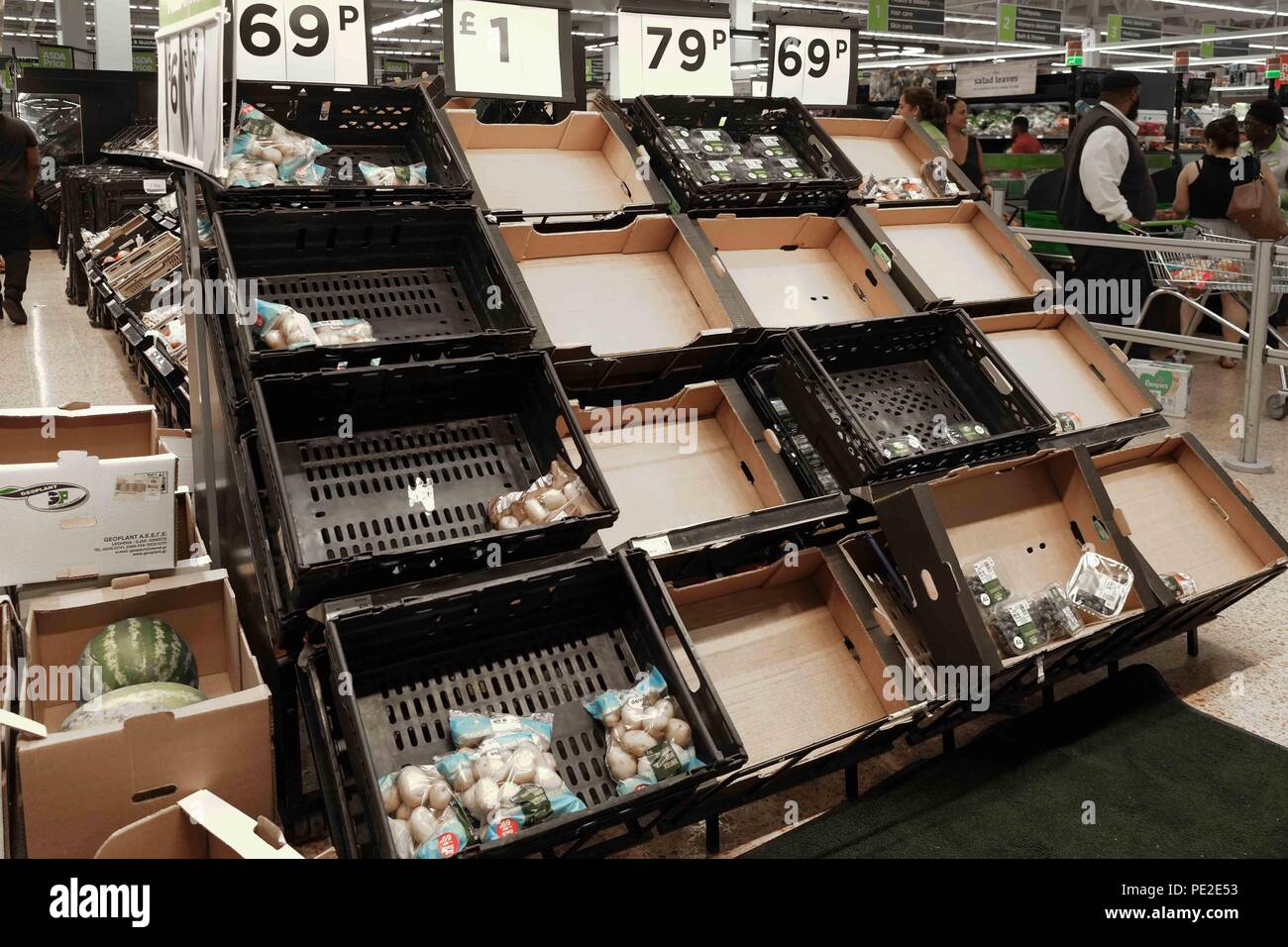 Nearly empty vegatable shelf in Asda Stock Photo