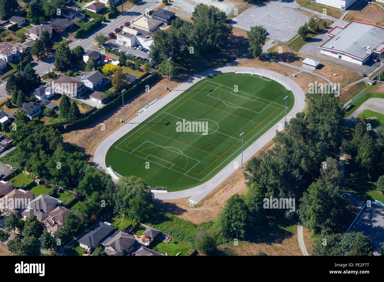 Aerial view of a green soccer field in an Elementary School. Taken in