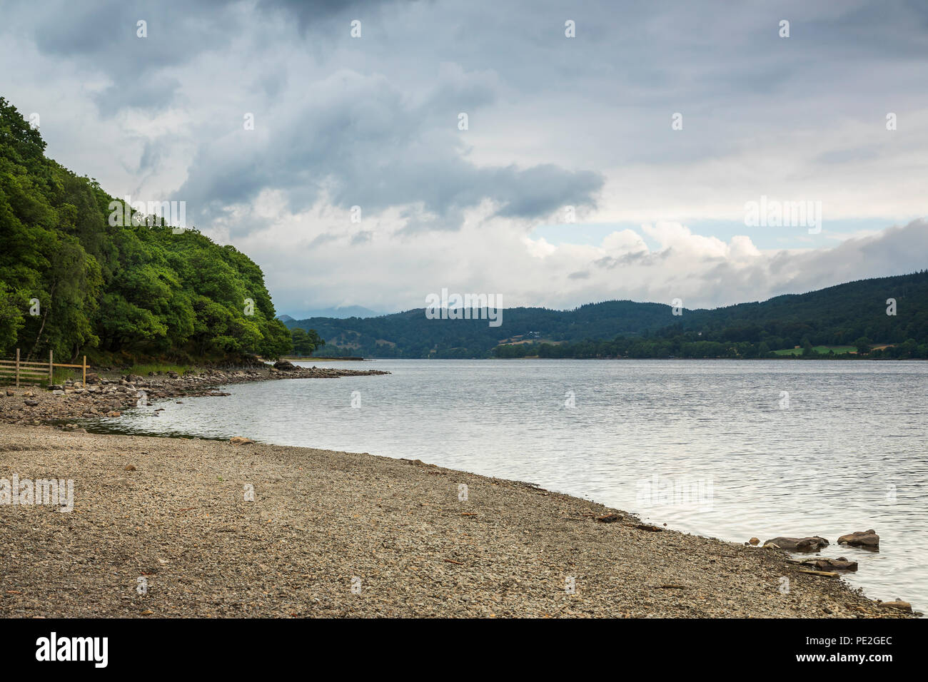 An image of the shoreline and dramatic sky at Coniston Water, Lake District, Cumbria, England, UK. Stock Photo