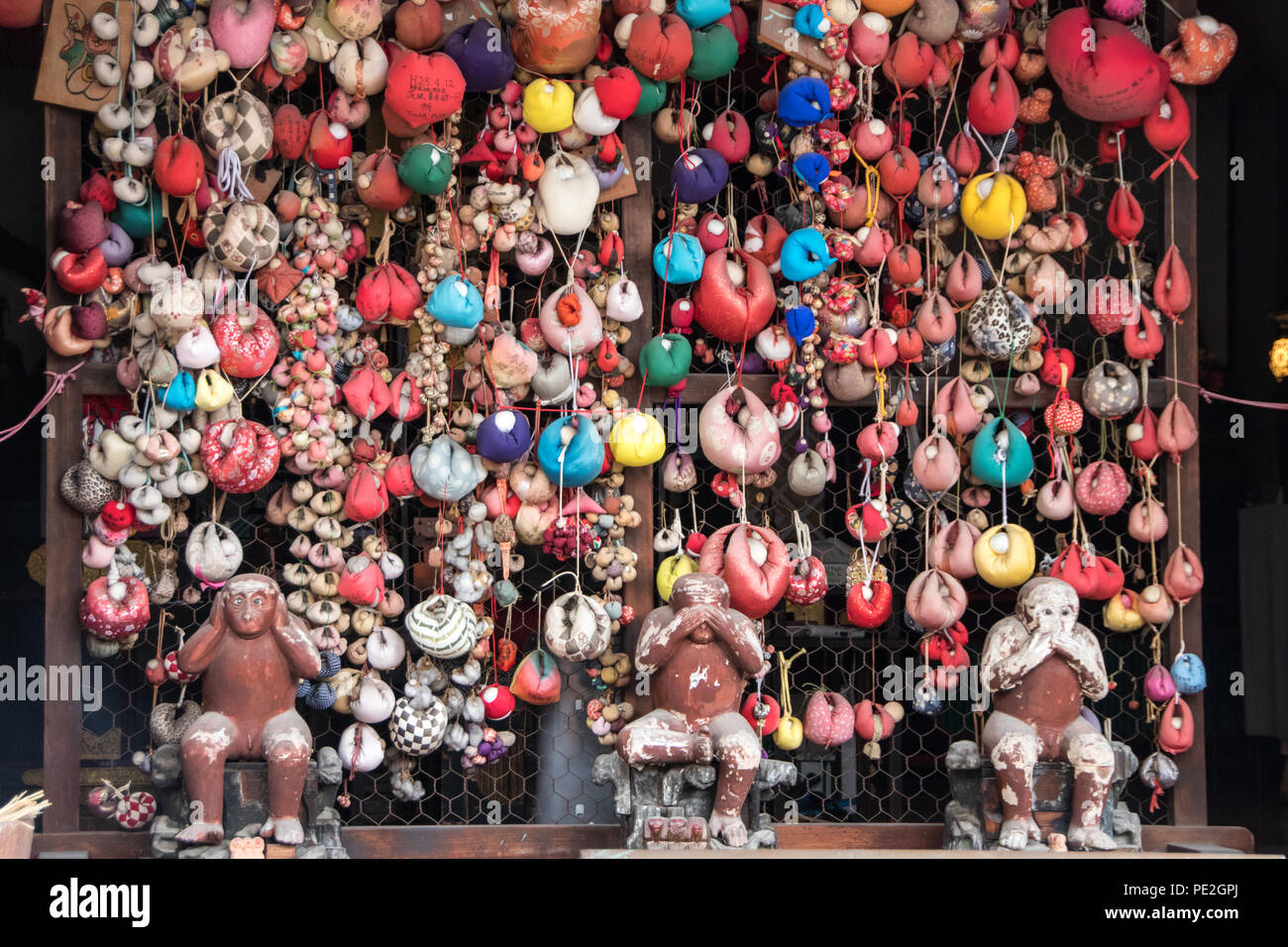 Colorful offerings for the three wise monkeys of the Yasaka Kōshin-dō in Higashiyama, Kyoto, Japan. Stock Photo