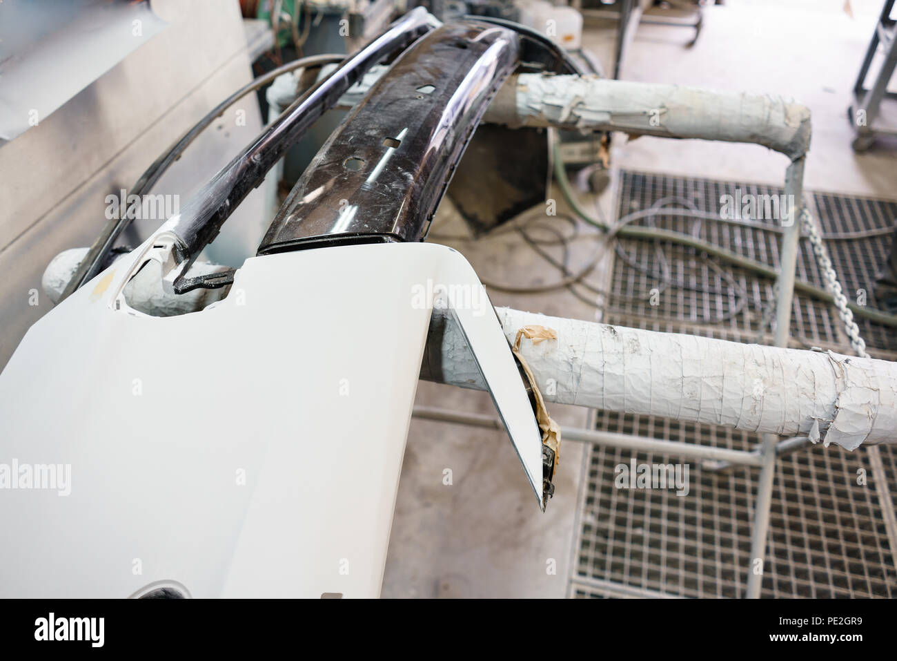 Garage painting car service. bumper section of the car is covered with