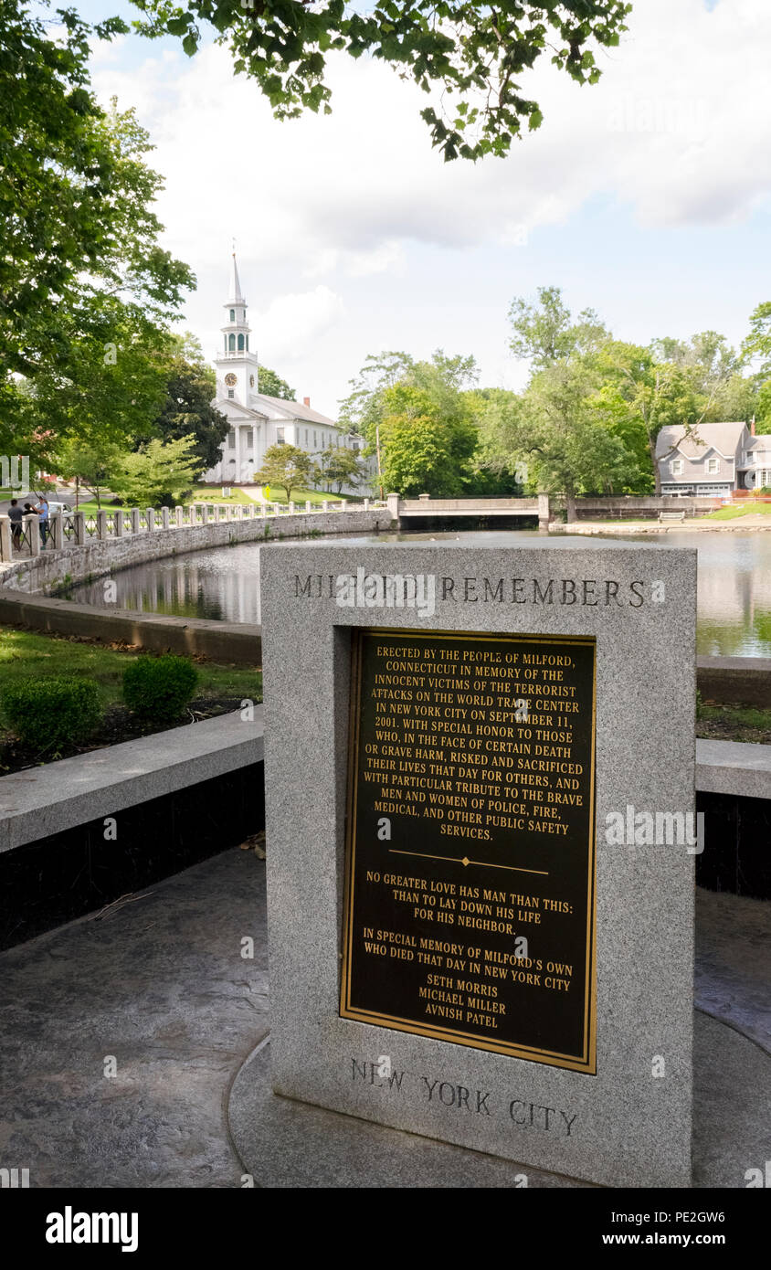 One of the many American memorials honoring victims of the infamous September11th terrorist attacks in 2001 is this three-sided slab of granite in the New England town of Milford, Connecticut, USA. Each side holds a bronze plaque describing one of the three places where passenger jet planes crashed in the attacks: the World Trade Center in New York City, the Pentagon in Washington D.C. and the field in Pennsylvania. This plaque memorializes three former Milford residents who died when the Twin Towers collapsed in New York. Stock Photo