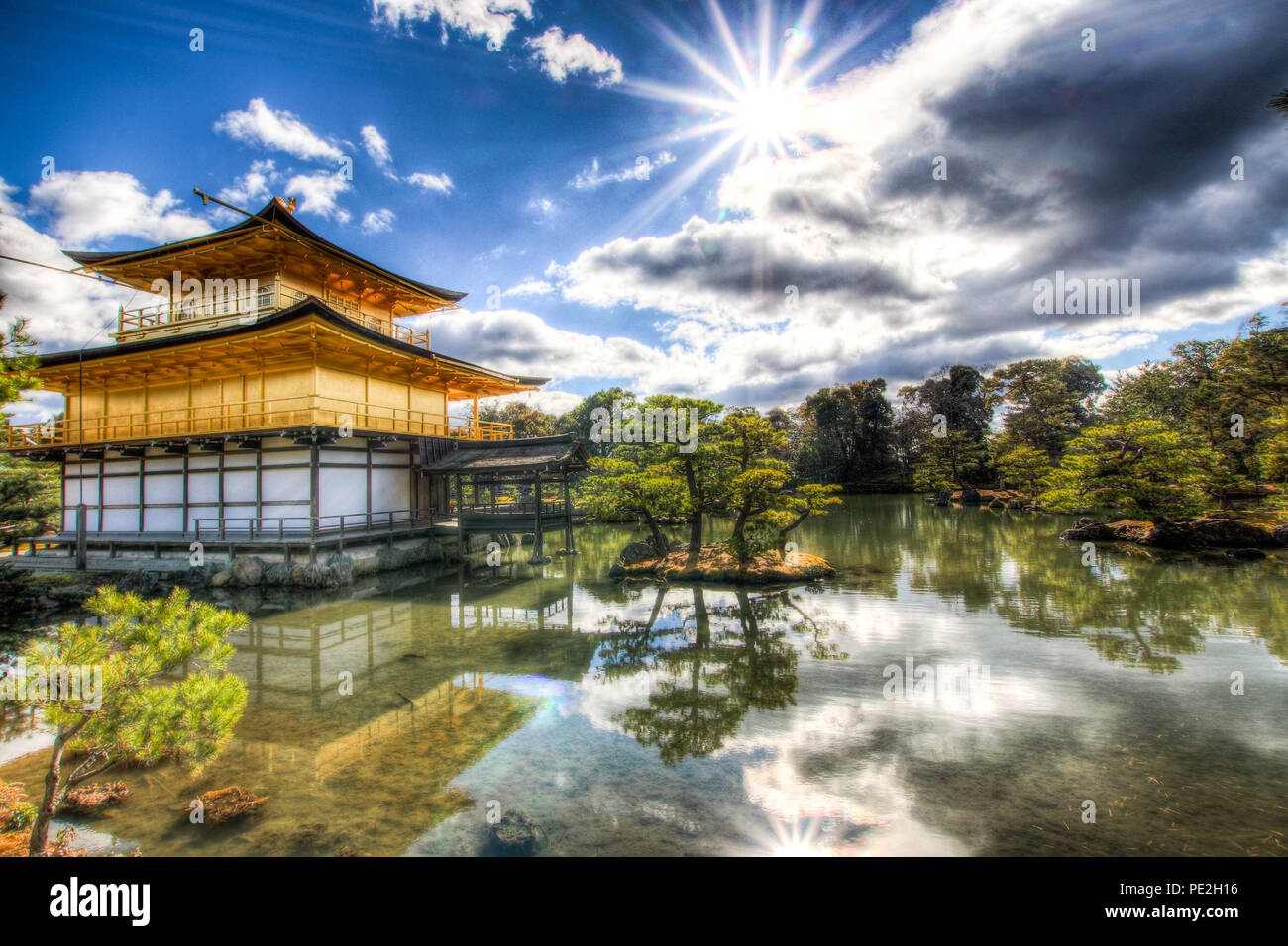 HDR image of the Kinkaku-ji temple (金閣寺, Temple of the Golden Pavilion) at the Kyoko-chi pond in Kyoto in the winter of 2017. Stock Photo