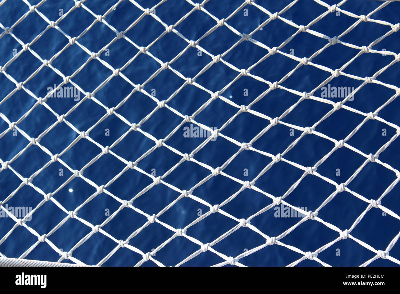 Deep blue water through a net Stock Photo