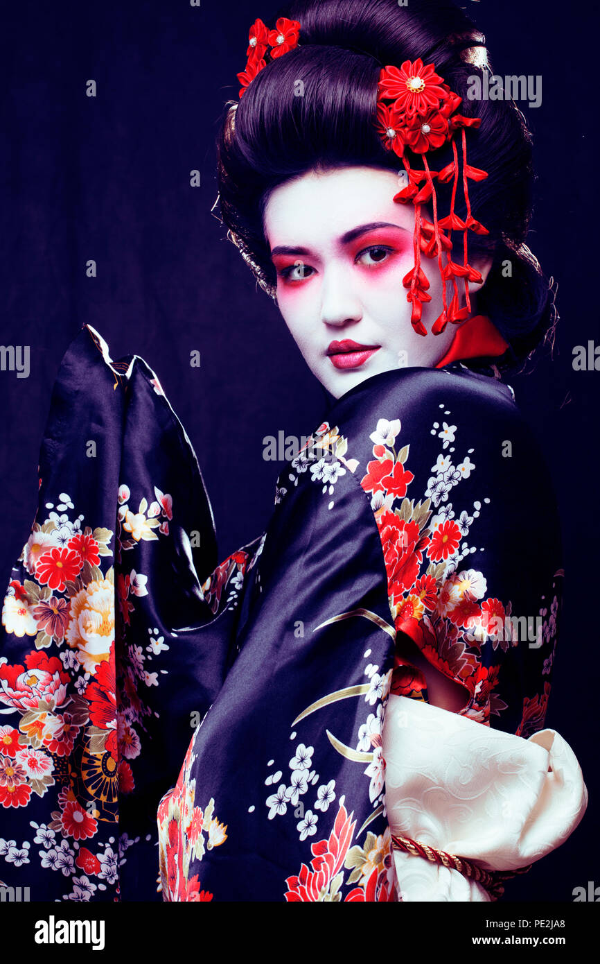 young pretty geisha in kimono with sakura and decoration on blac Stock  Photo - Alamy