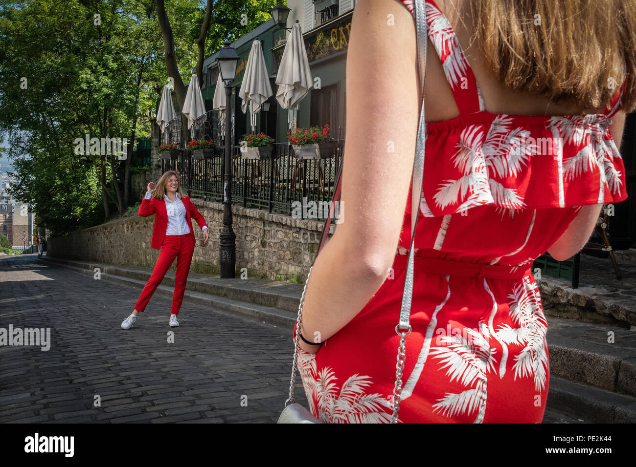 Young, fashionable women dressed in red standing on the street in Montmartre, Paris, France. Stock Photo