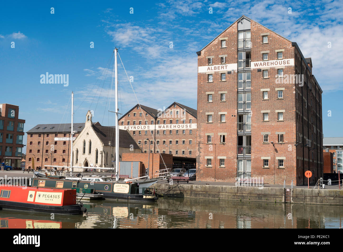 Warehouses and Mariner's chapel seen from the Victoria basin, Gloucester docks, Gloucestershire, England, UK Stock Photo