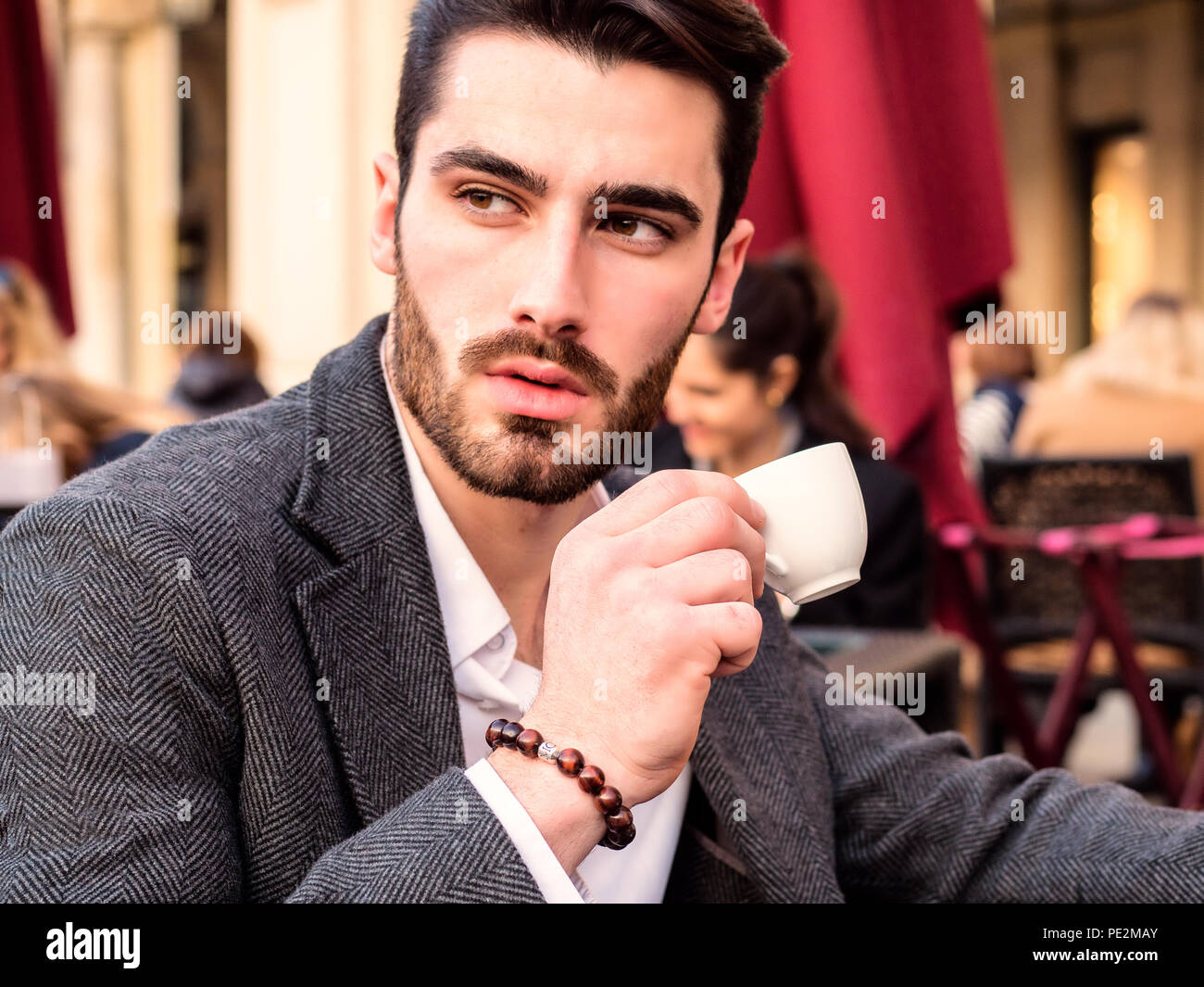 Handsome young businessman drinking espresso coffee Stock Photo