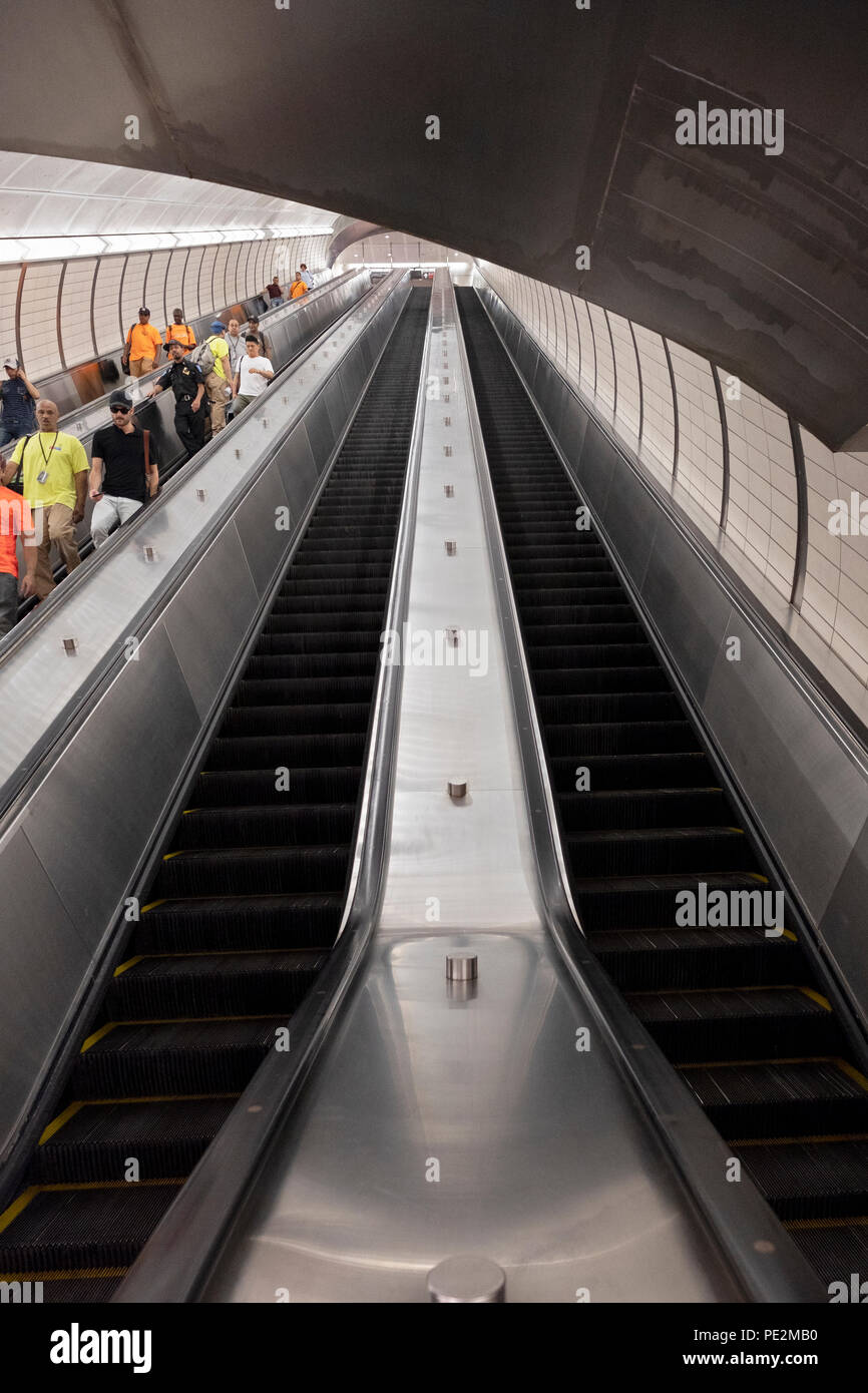 A long escalator from the platform to the mezzanine at the Hudson Yards subway station in Manhattan, NYC. Stock Photo