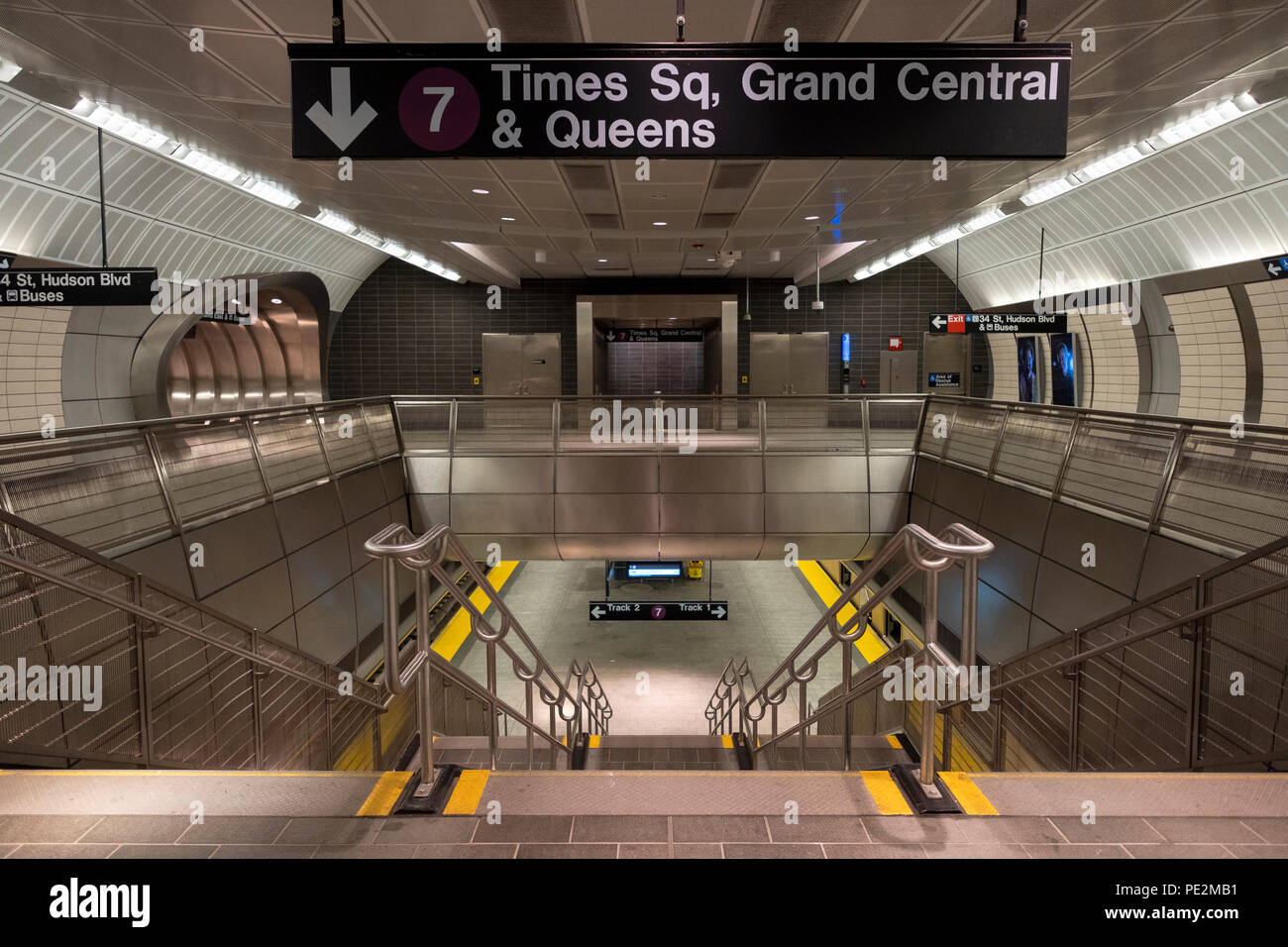 The staircase from the mezzanine to the subway platform at the Hudson Yards station in Manhattan, NYC. Stock Photo