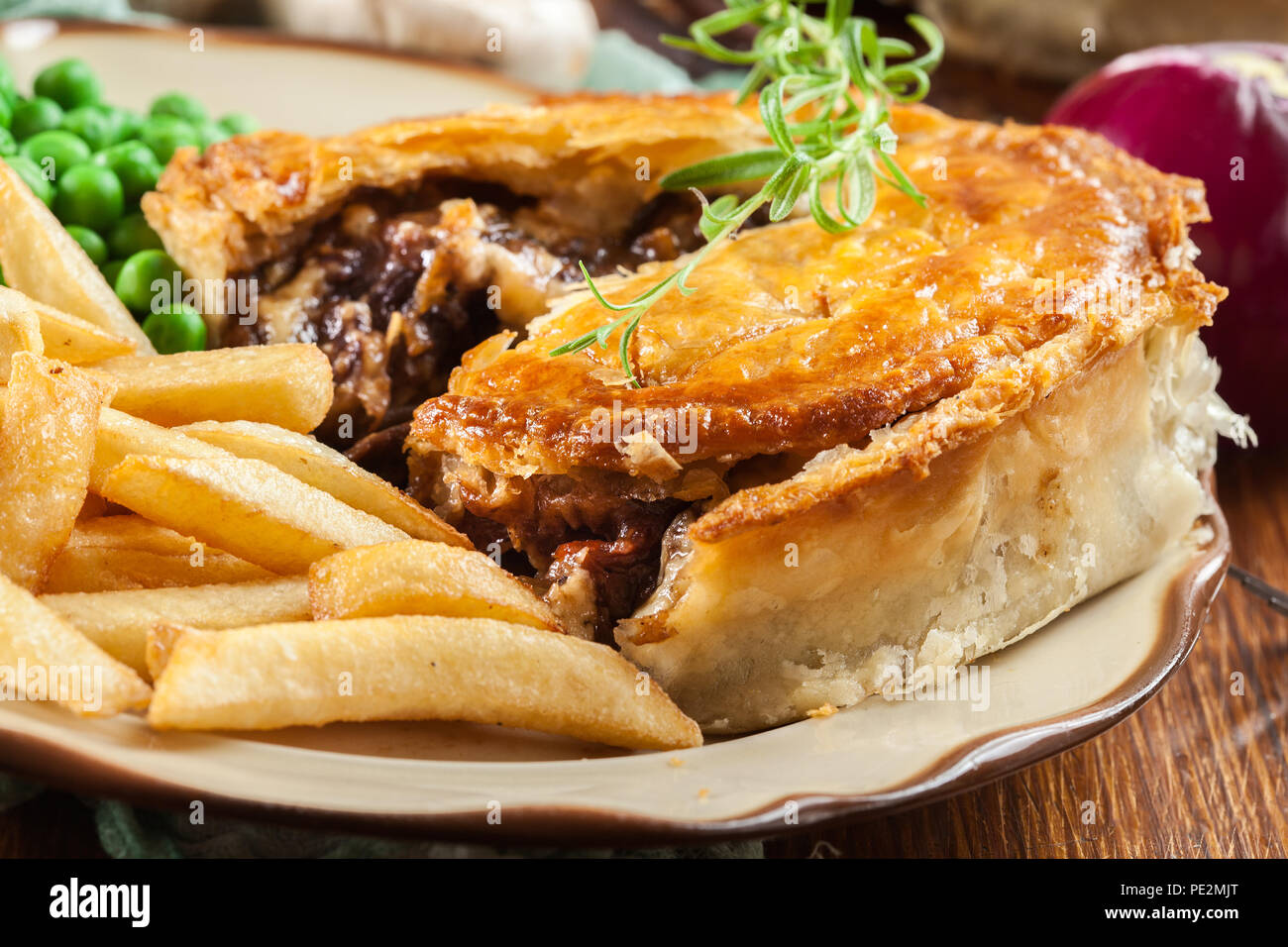 Homemade beef stew pie with french fries. Meat in puff pastry Stock