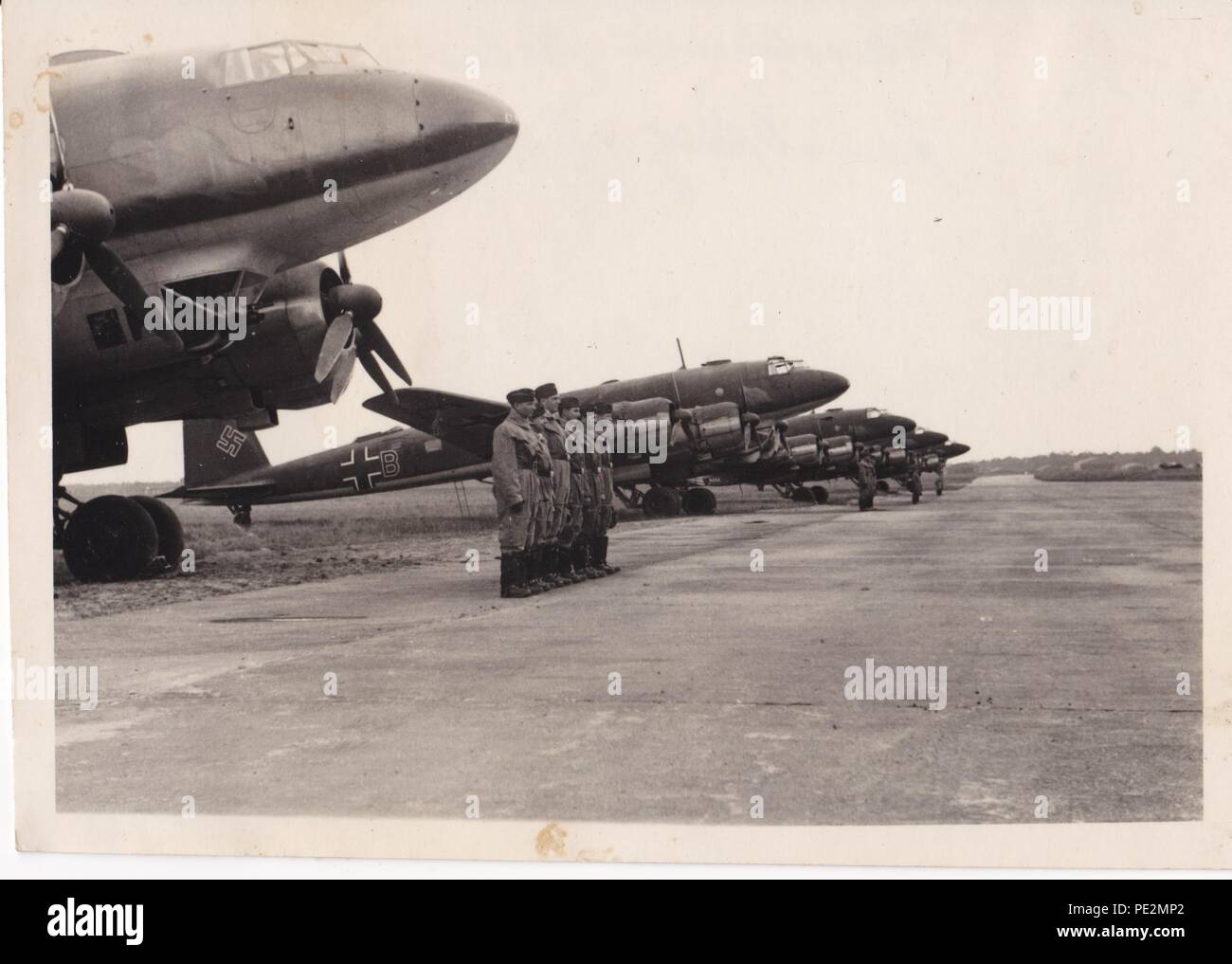 Image from the photo album of Oberfeldwebel Karl Gendner of 1. Staffel, Kampfgeschwader 40: Oberfeldwebel Karl Gendner and his crew from 1./KG 40 (in foreground) with Focke Wulf FW 200 Condor aircraft and crews of I. Gruppe KG 40, ready for a mission on 28th June 1941. The censor has removed the KG 40 emblems on the front of the aircraft. Stock Photo