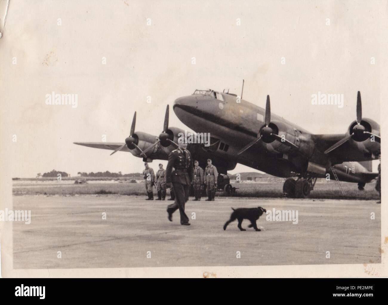 Image from the photo album of Oberfeldwebel Karl Gendner of 1. Staffel, Kampfgeschwader 40: Hauptmann Konrad Verlohr, Staffelkapitän of 1./KG 40, passes in front of Oberfeldwebel Karl Gendner and his crew at Bordeaux, 28th June 1941. The censor has removed the KG 40 emblems on the front of the aircraft. Stock Photo