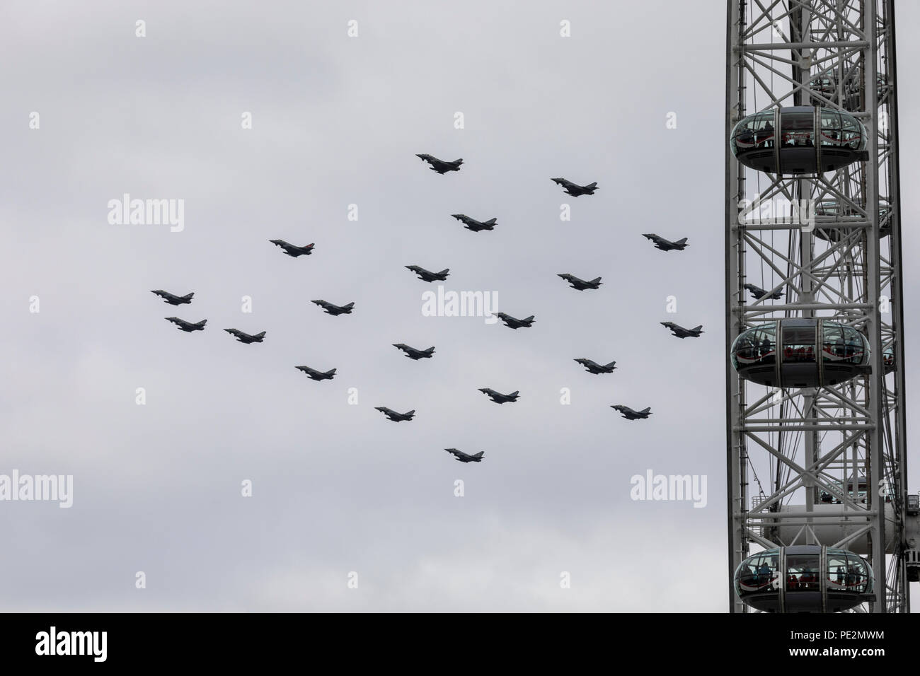 Many Eurofight Typhoon RAF fighter jets in formation over London for the RAF100 anniversary flypast passing the London Eye Stock Photo