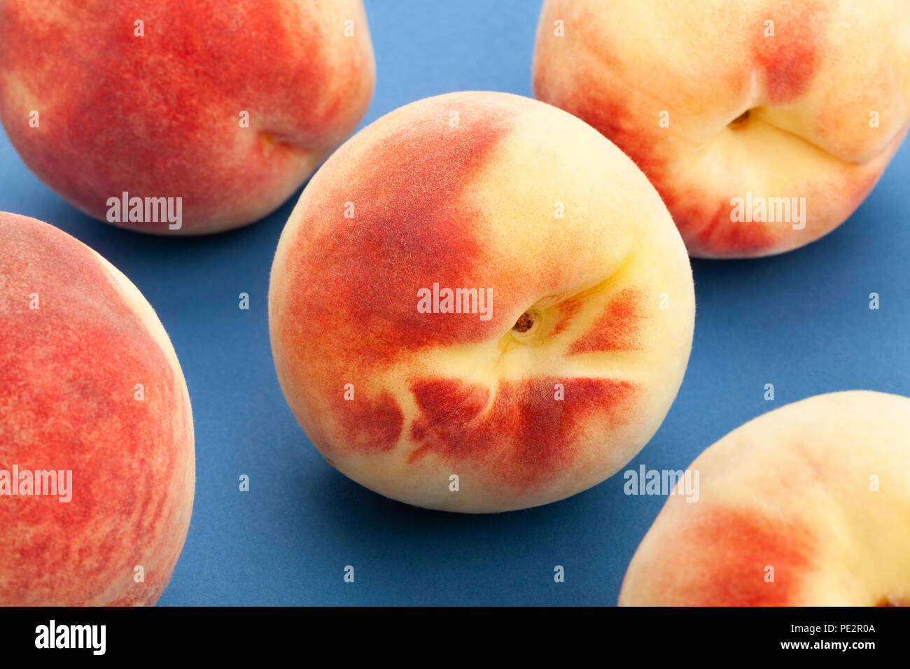 white peach closeup on blue background Stock Photo