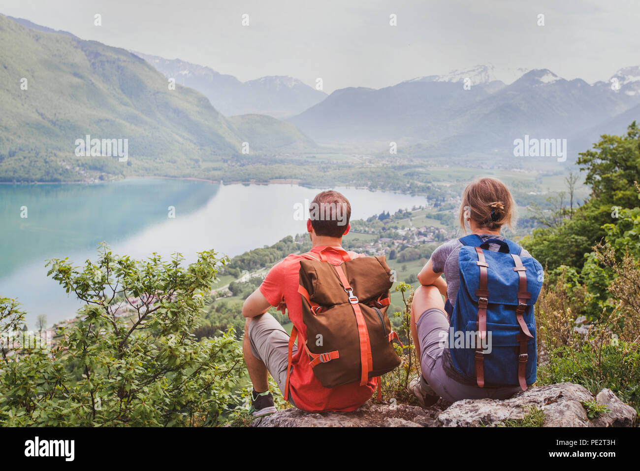 travel, two hikers enjoying beautiful panoramic mountain view, summer hiking in Alps Stock Photo