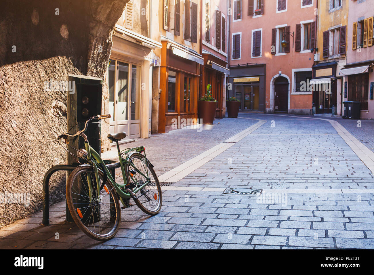 beautiful cozy street in Annecy early morning, France, vintage bicycle on pavement in Europe, european old town cityscape, historical architecture arc Stock Photo