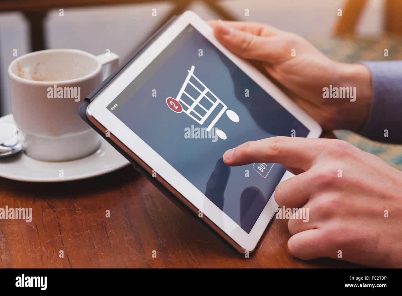 online shopping concept on the screen of digital tablet computer device, buy goods online, e-commerce, closeup of finger Stock Photo