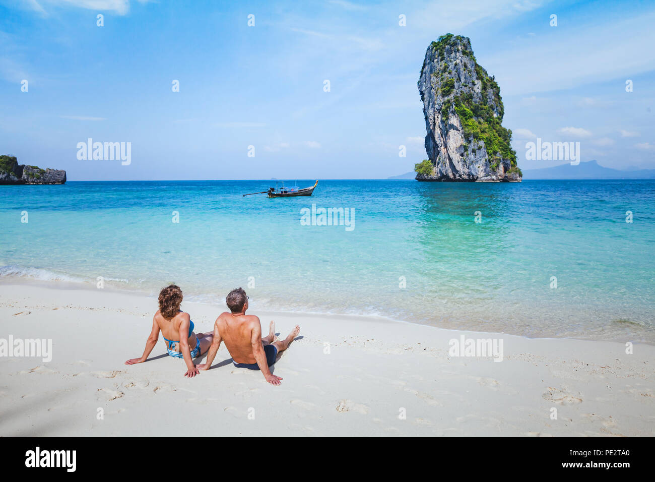 travel to Thailand, honeymoon family couple enjoying sunbath and sea on paradise beach, holiday tourism and relaxation Stock Photo