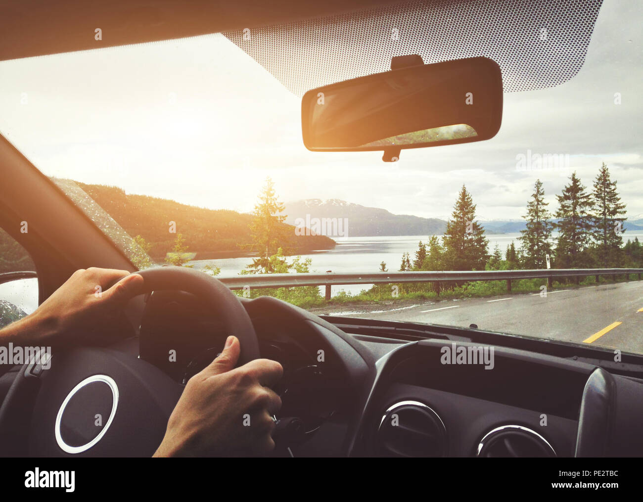 driving car in Norway, roadtrip, hands of driver on steering wheel Stock Photo