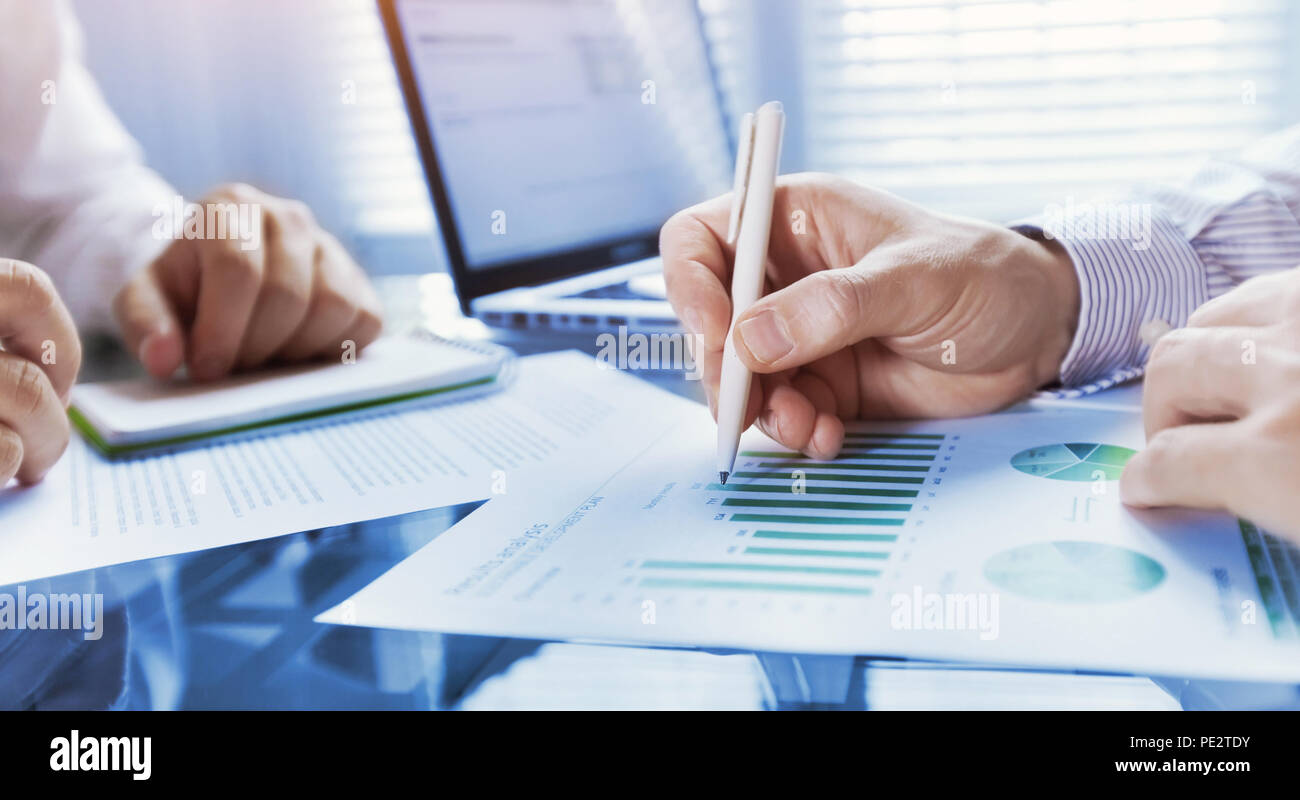 business analytics, team of people working on financial report in the office, teamwork, closeup of hands Stock Photo