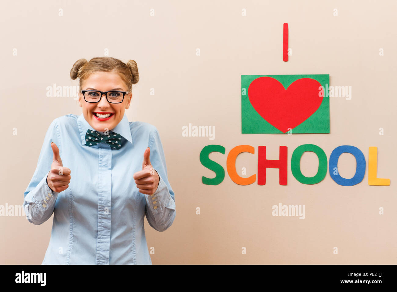 Portrait of nerdy student showing thumb up for school Stock Photo - Alamy