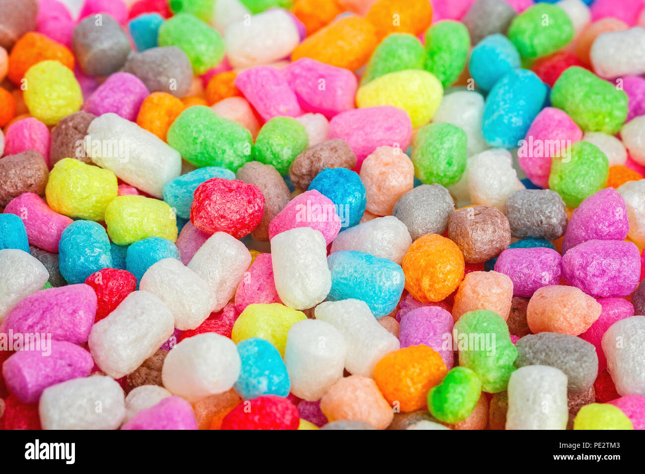 Multicolored corn balls lie on the table. Background. A game for