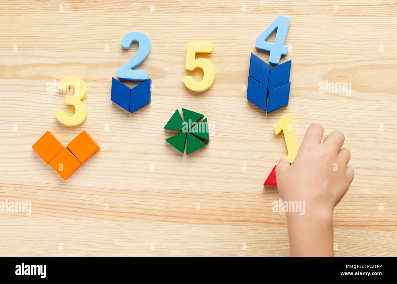 The child is studying the numbers and the account. Arranges the colored ...