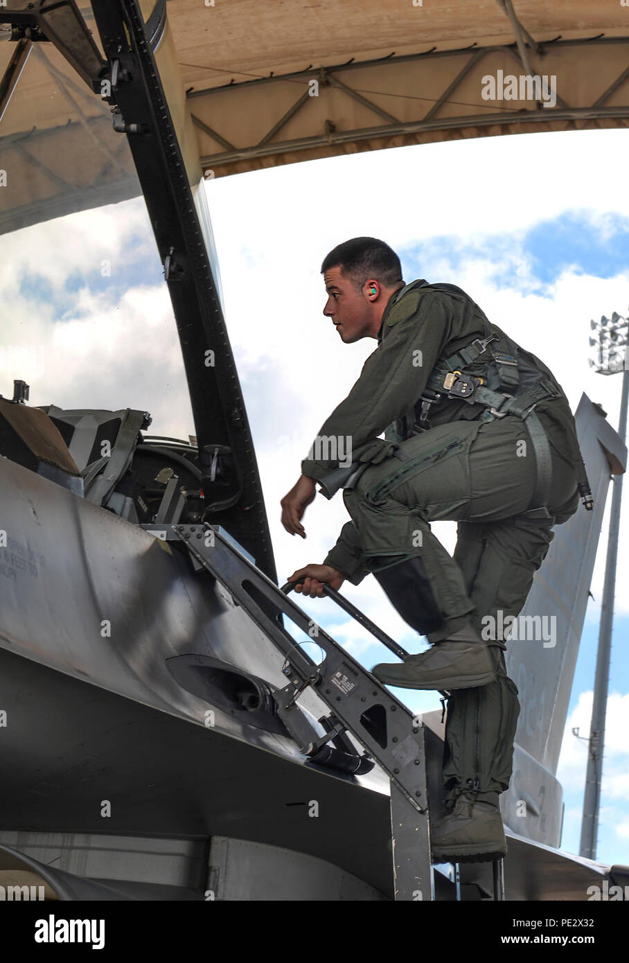 Senior Airman Samuel Ellis, 33rd Operations Group intelligence analyst, climbs on board an F-16 Fighting Falcon assigned to the South Carolina Air National Guard’s 169th Fighter Wing for an incentive flight at Eglin Air Force Base, Fla., Sept. 17, 2015. The 169th FW spent two weeks conducting fifth generation integration training with the 58th Fighter Squadron. (U.S. Air Force Photo/Senior Airman Andrea Posey) Stock Photo
