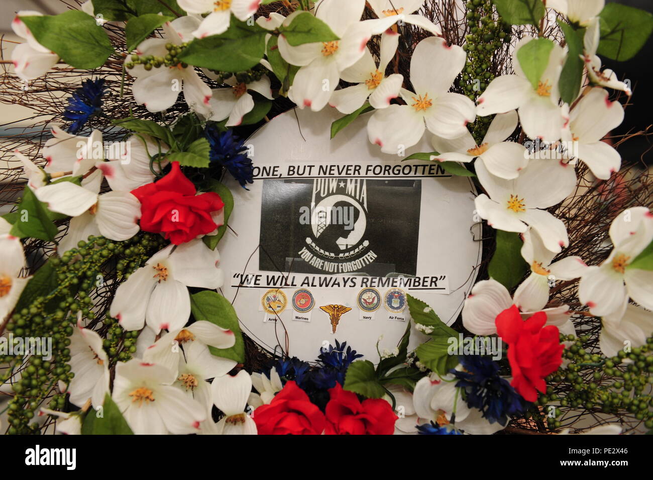 A wreath honoring prisoners of war and those who are missing in action sits on display during a POW/MIA Remembrance Ceremony at the Pima Air and Space Museum in Tucson, Ariz., Sept. 18, 2015. The wreath was crafted and donated by Ms. Helen Glass, a U.S. Navy World War II veteran who served in Women Accepted for Volunteer Emergency Service. (U.S. Air Force photo by Senior Airman Cheyenne A. Powers/ Released) Stock Photo