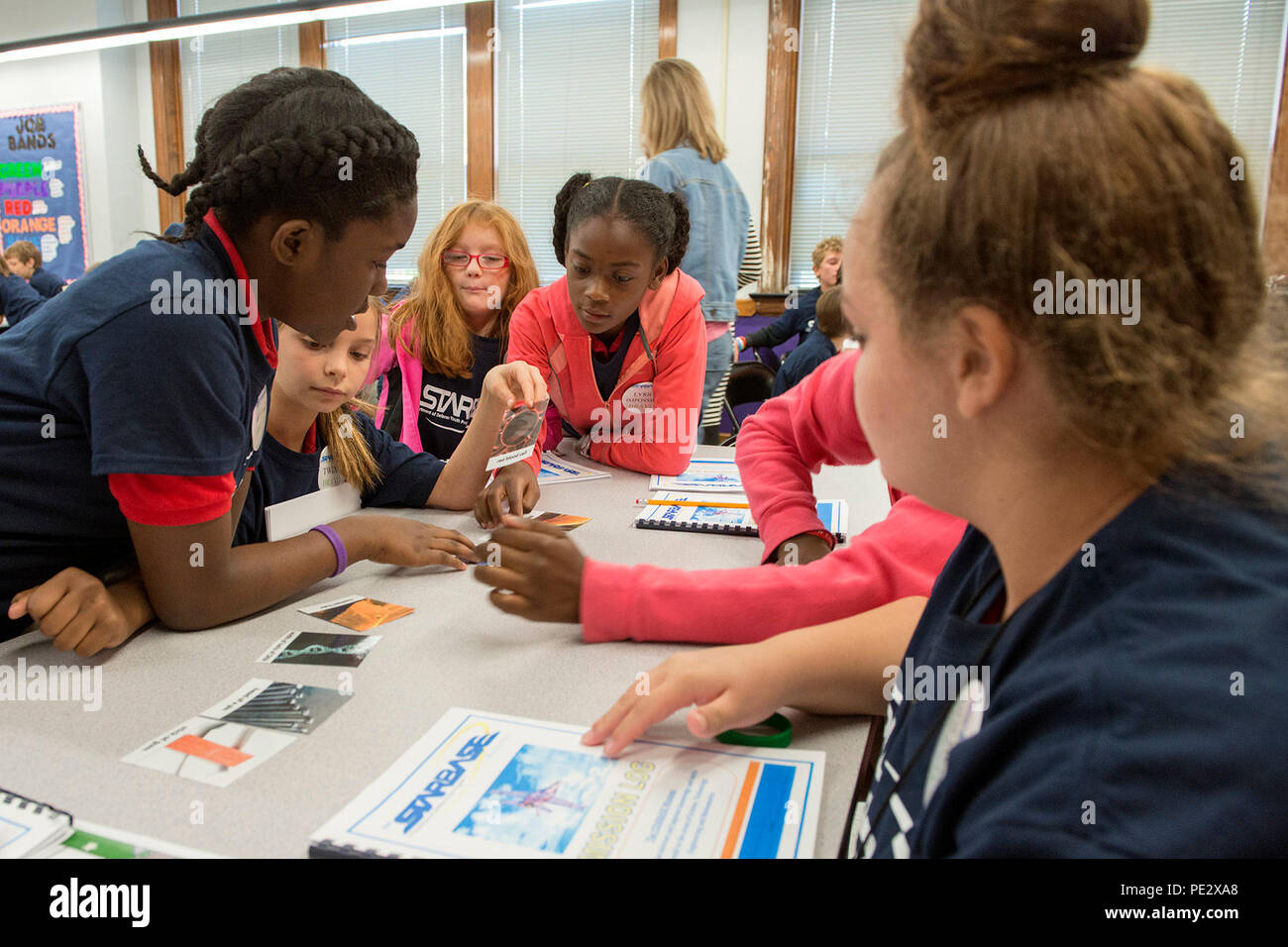 Fifth graders from Crescent Elementary in Plaquemine, La., place picture cards in order of size during a class at the Louisiana National Guard youth program Bayou State STARBASE in Rosedale, La., Sept. 24, 2015. LANG STARBASE programs have educated more than 13,000 students across the state since the first program open in New Orleans in 1999. (Air National Guard photo by Master Sgt. Toby M. Valadie/Released) Stock Photo