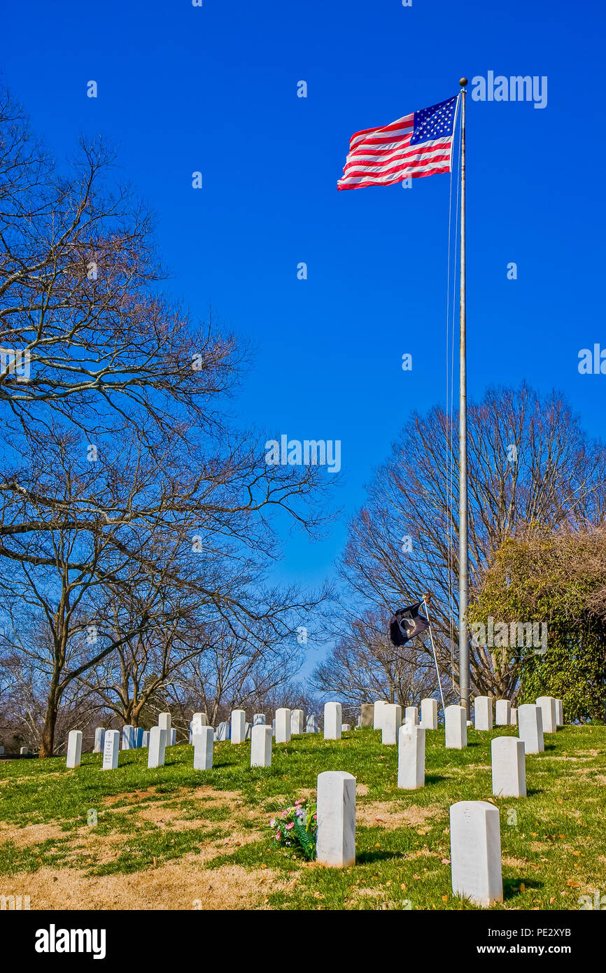 An American flag at military cemetery with gravestones Stock Photo - Alamy