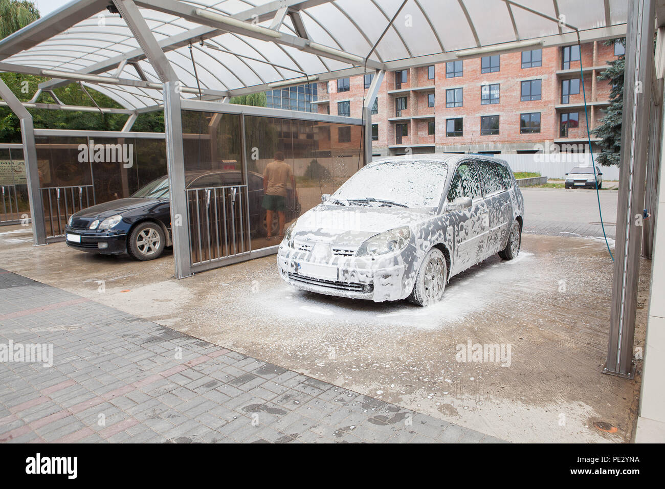 Car wash with foam in car wash station. Carwash. Washing machine