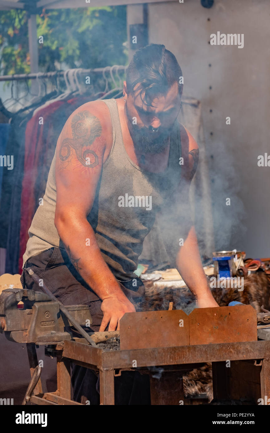 A blacksmith toils over a hot forge at the annual Steampunk Festival in Coldwater Ontario. Stock Photo