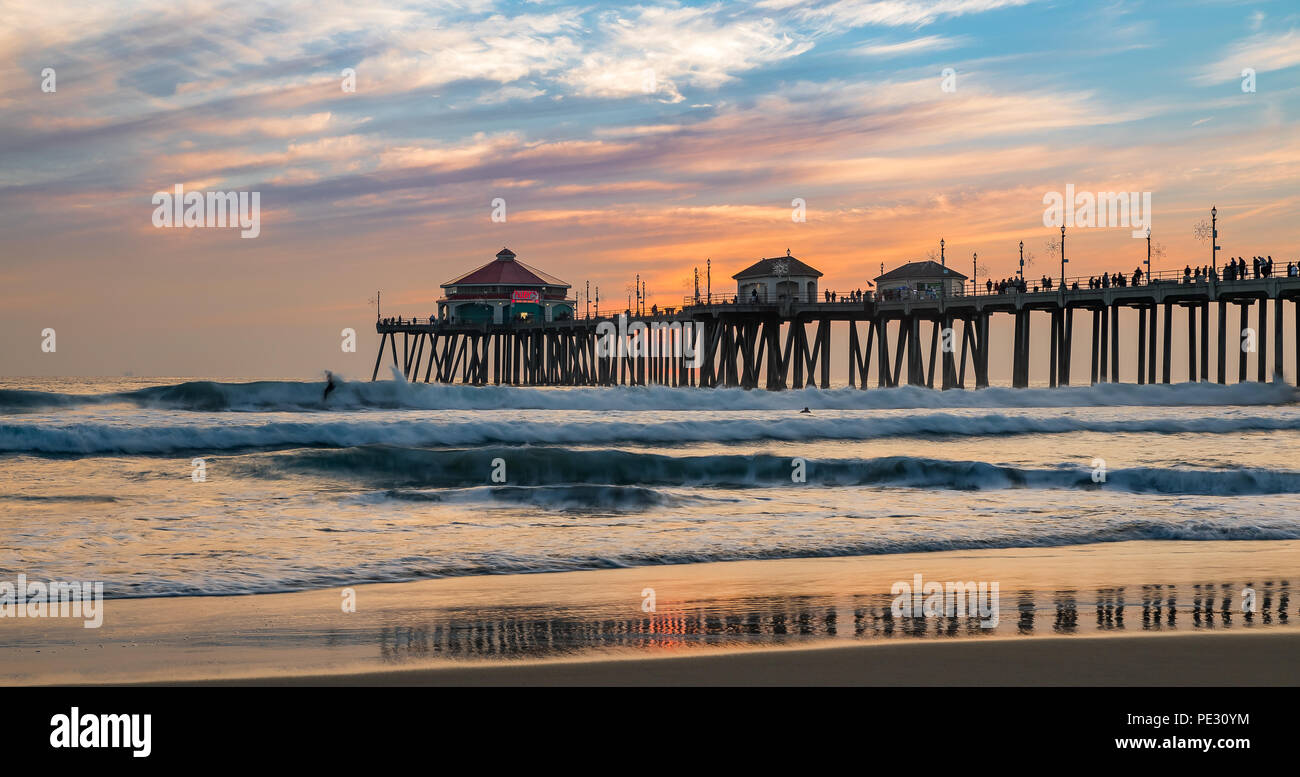 Incredible colors of the sunset by Huntington Beach Pier, in the famous surf city in California Stock Photo