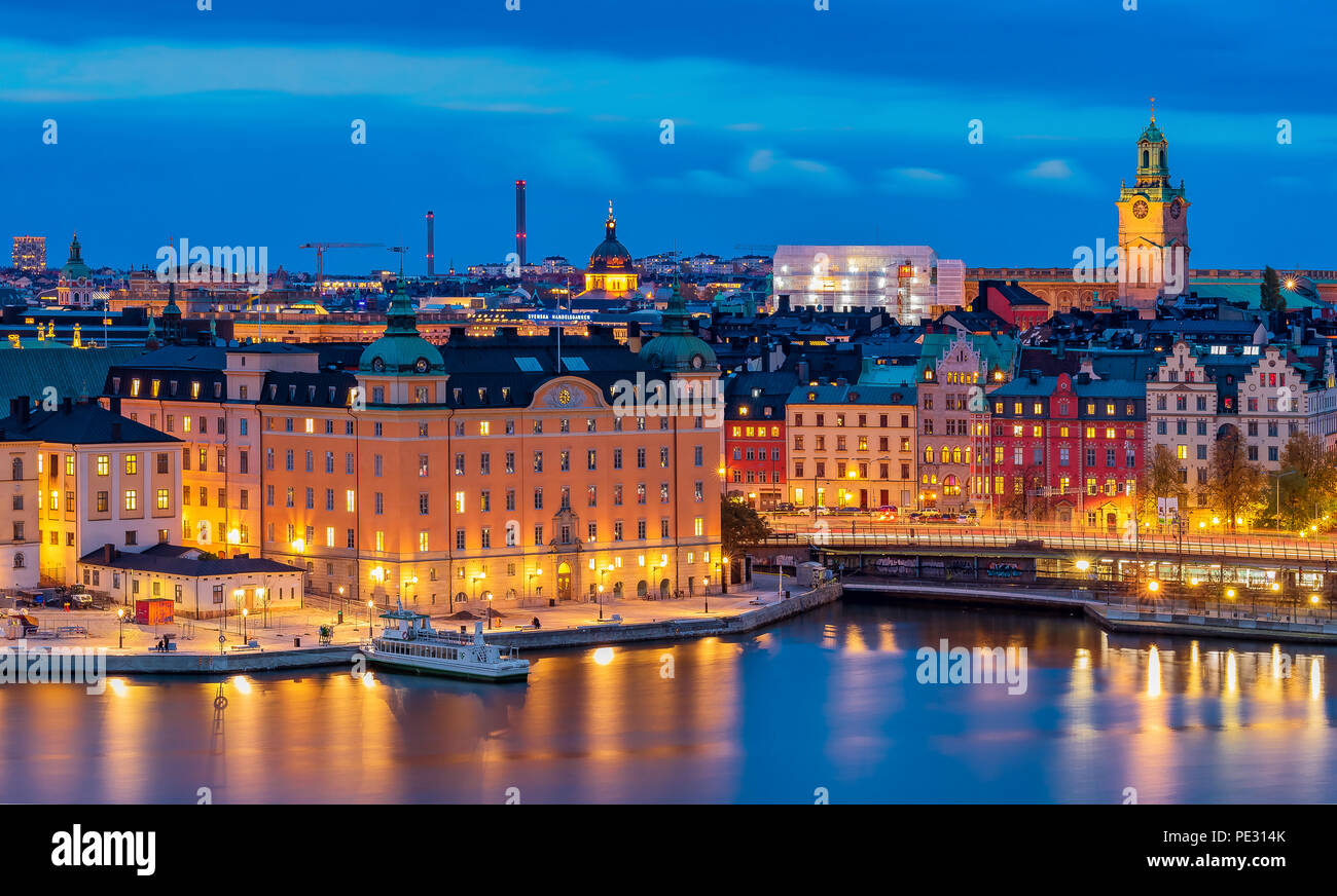 Stockholm, Sweden - October 24, 2017: Sunset panoramic view across Lake Malaren onto Storkyrkan or Stockholm Cathedral and traditional gothic building Stock Photo