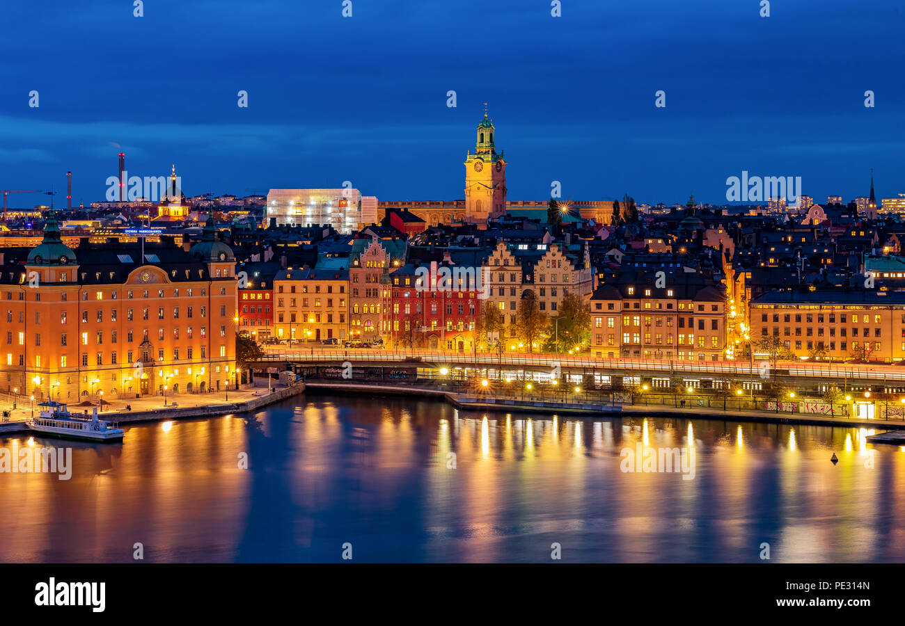 Stockholm, Sweden - October 24, 2017: Sunset panoramic view across Lake Malaren onto Storkyrkan or Stockholm Cathedral and traditional gothic building Stock Photo