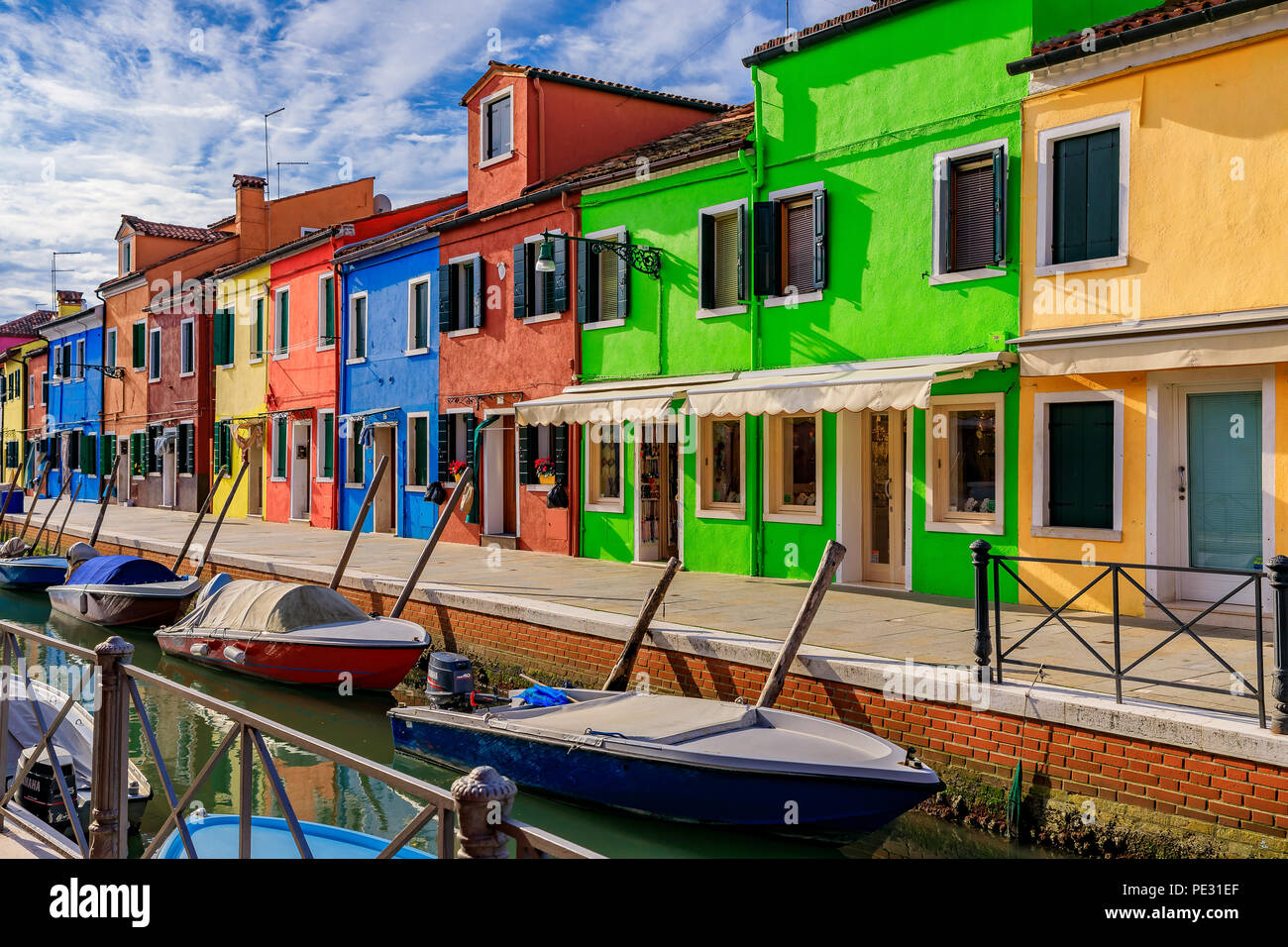 Picturesque canal and bright and colorful houses in Burano island near
