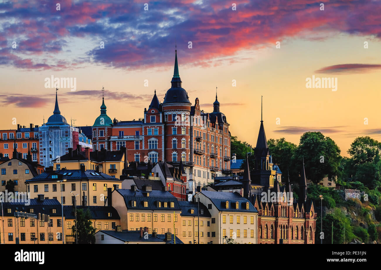 Stunning sunset clouds above the traditional gothic buildings in the Sodermalm part of Stockholm, Sweden Stock Photo