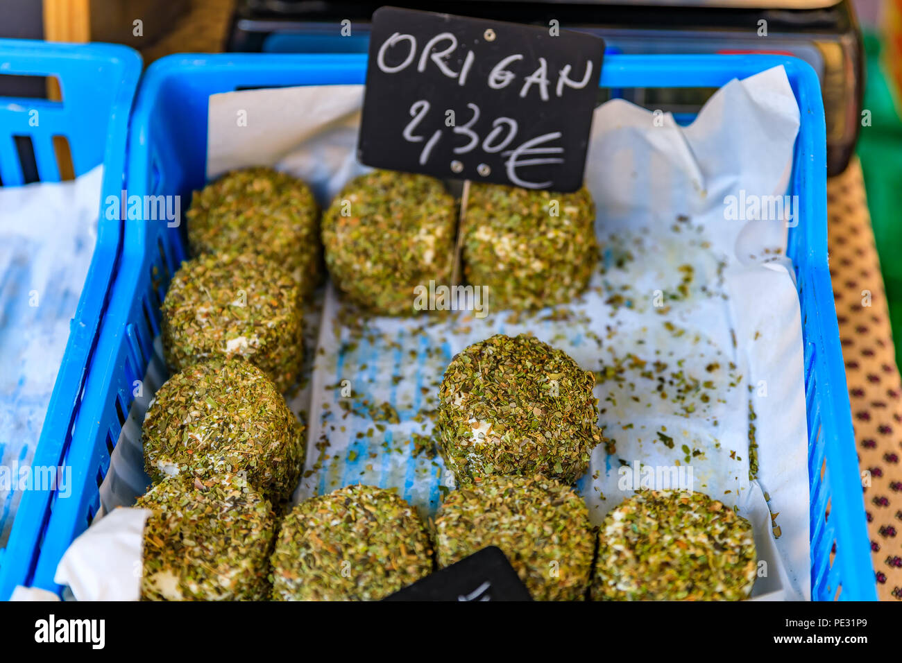 Herb coated cheese at a local outdoor farmers market in Nice, France Stock Photo