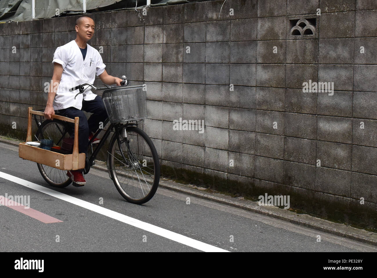 Japanese Worker Riding A Bicycle Kyoto Stock Photo Alamy