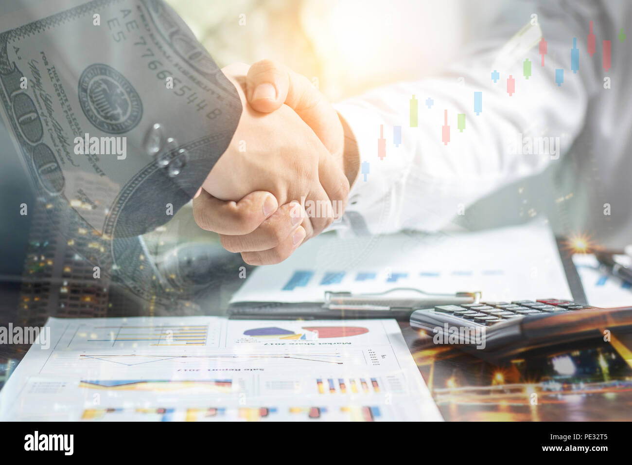 Double exposure of handshake and night city, Successful negotiating business concept, Businessmen shaking hands after finishing meeting or setting  go Stock Photo