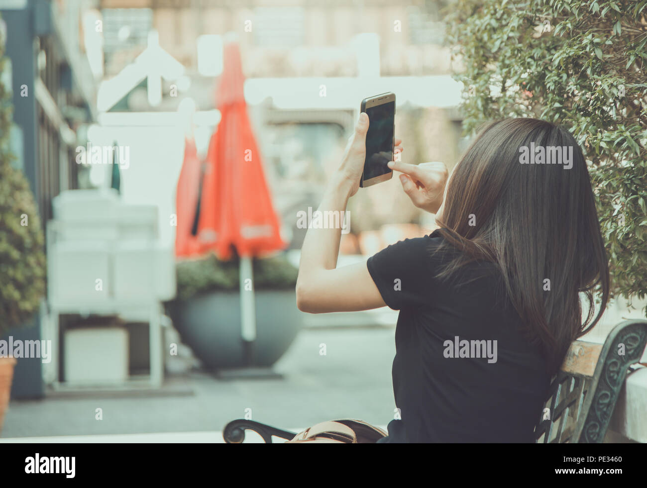 Girl using mobile phone selfies  in places outdoors  happily. Stock Photo