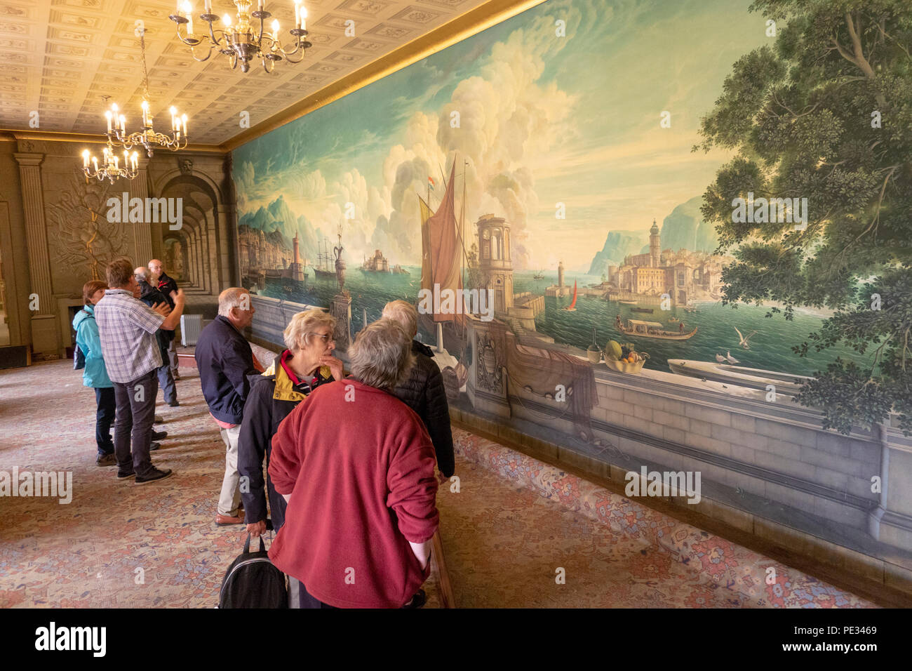 UK, Wales, Anglesey, Plas Newydd House, dining room, visitors admiring Rex Whistler painting Stock Photo