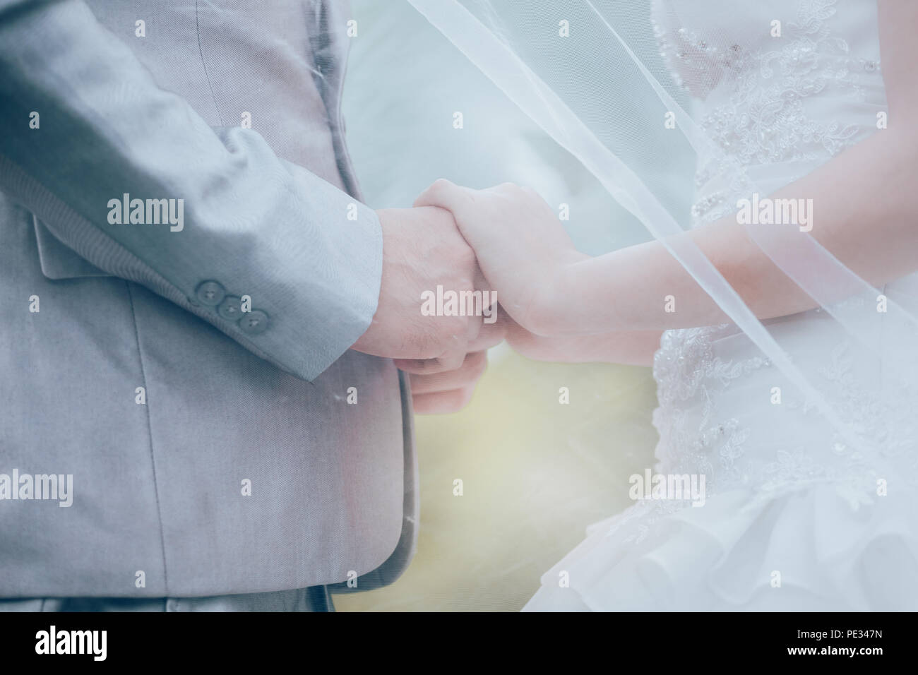 Married bride and groom holding hands as a symbol of love and happiness. Stock Photo