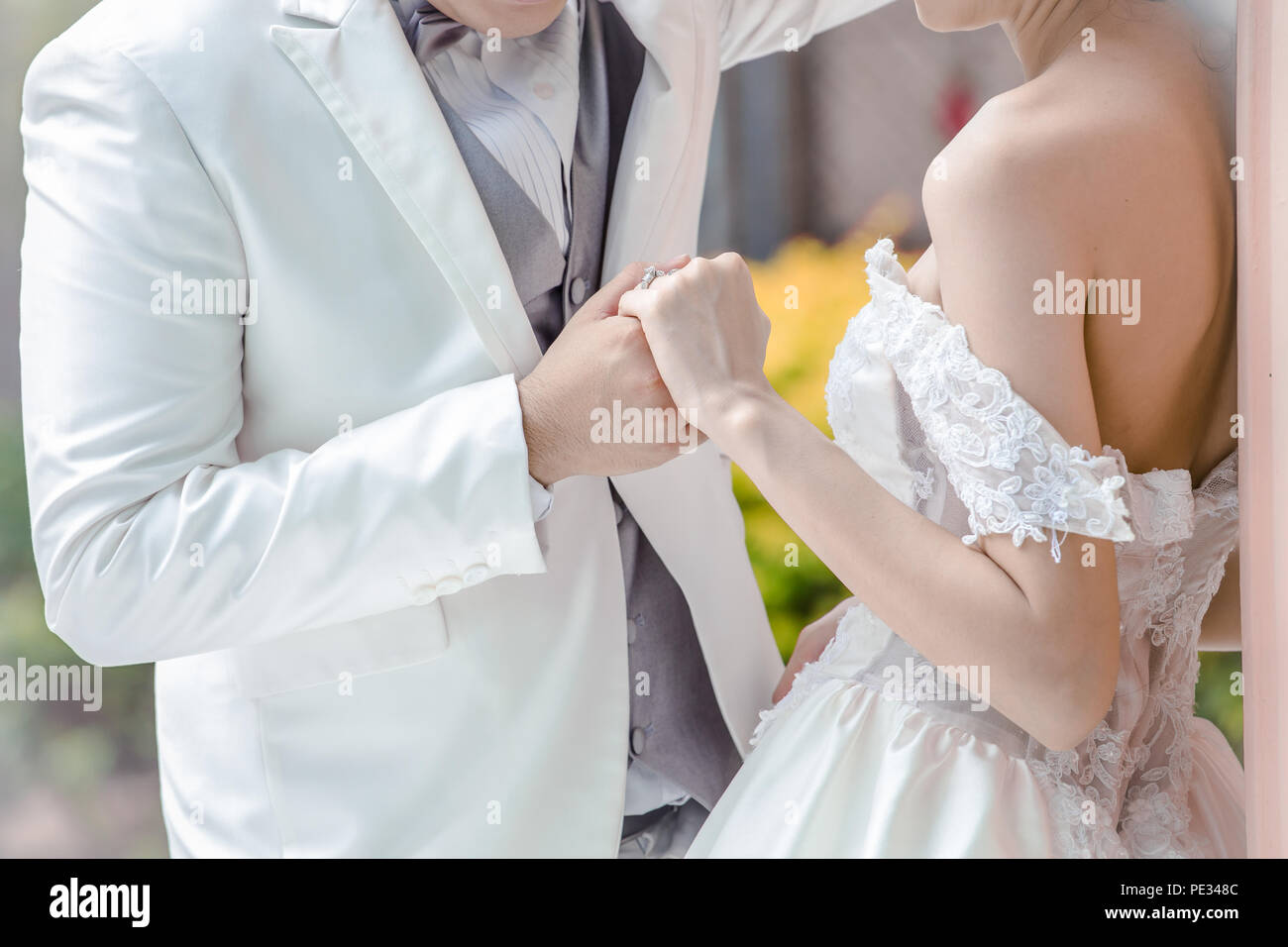 Wedding couple holding hands a symbol of love and marriage. Stock Photo